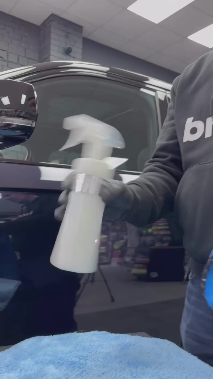 Detailer applying Fireball Duke wax to vehicle hood, showcasing smooth spread and high-gloss finish.